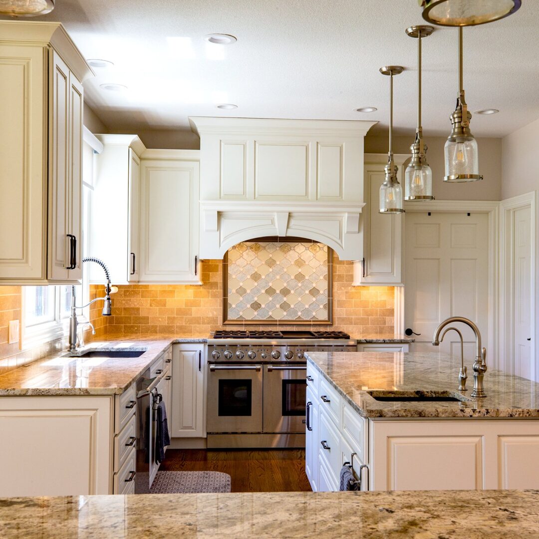 A kitchen with white cabinets and granite counter tops.