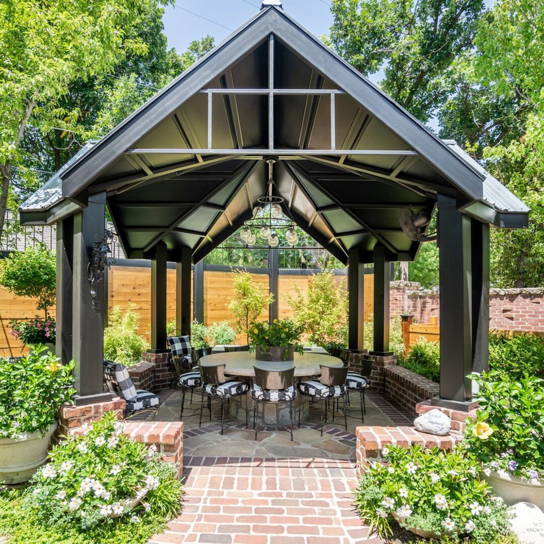 A gazebo with chairs and tables in the middle of it.
