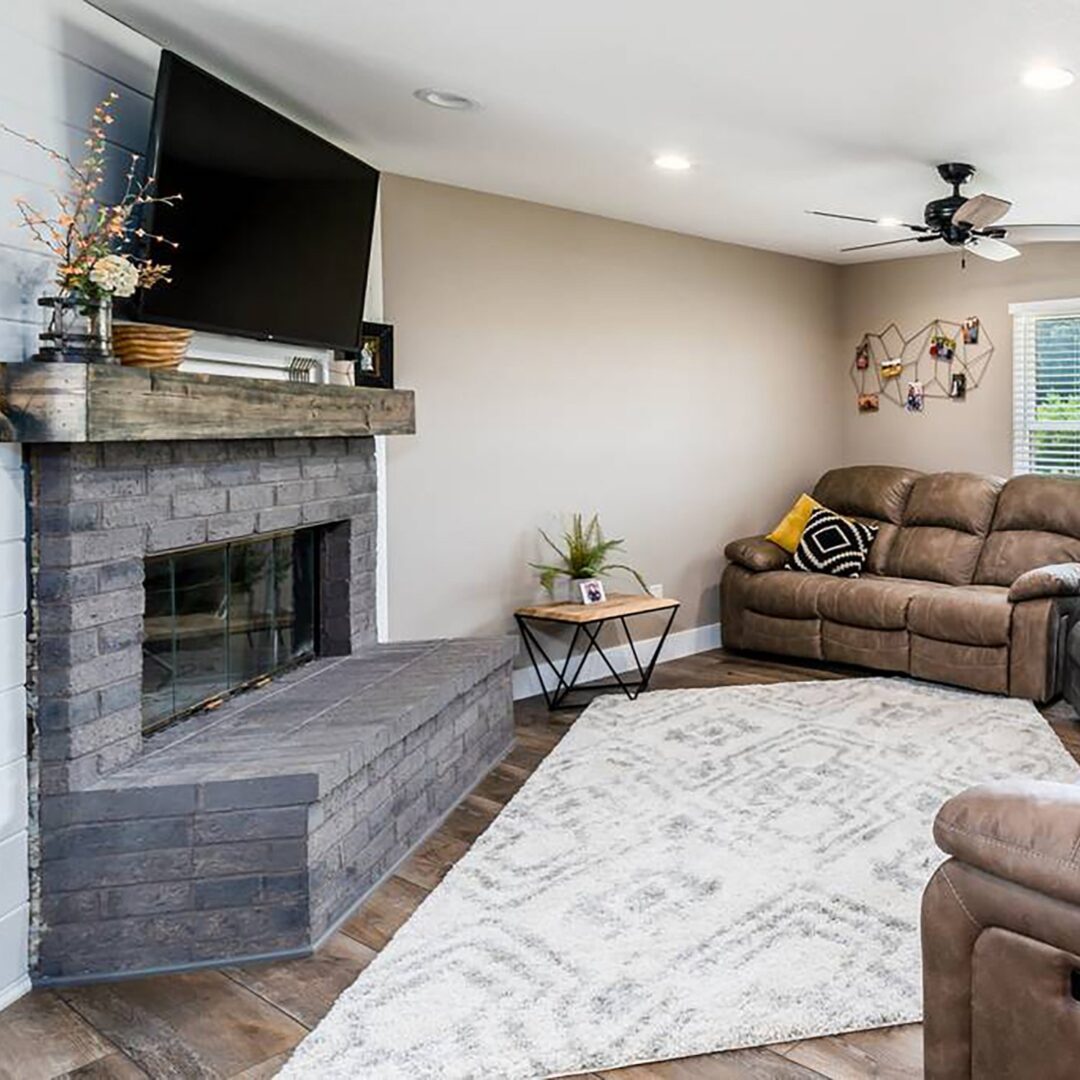 A living room with a fireplace and a tv.