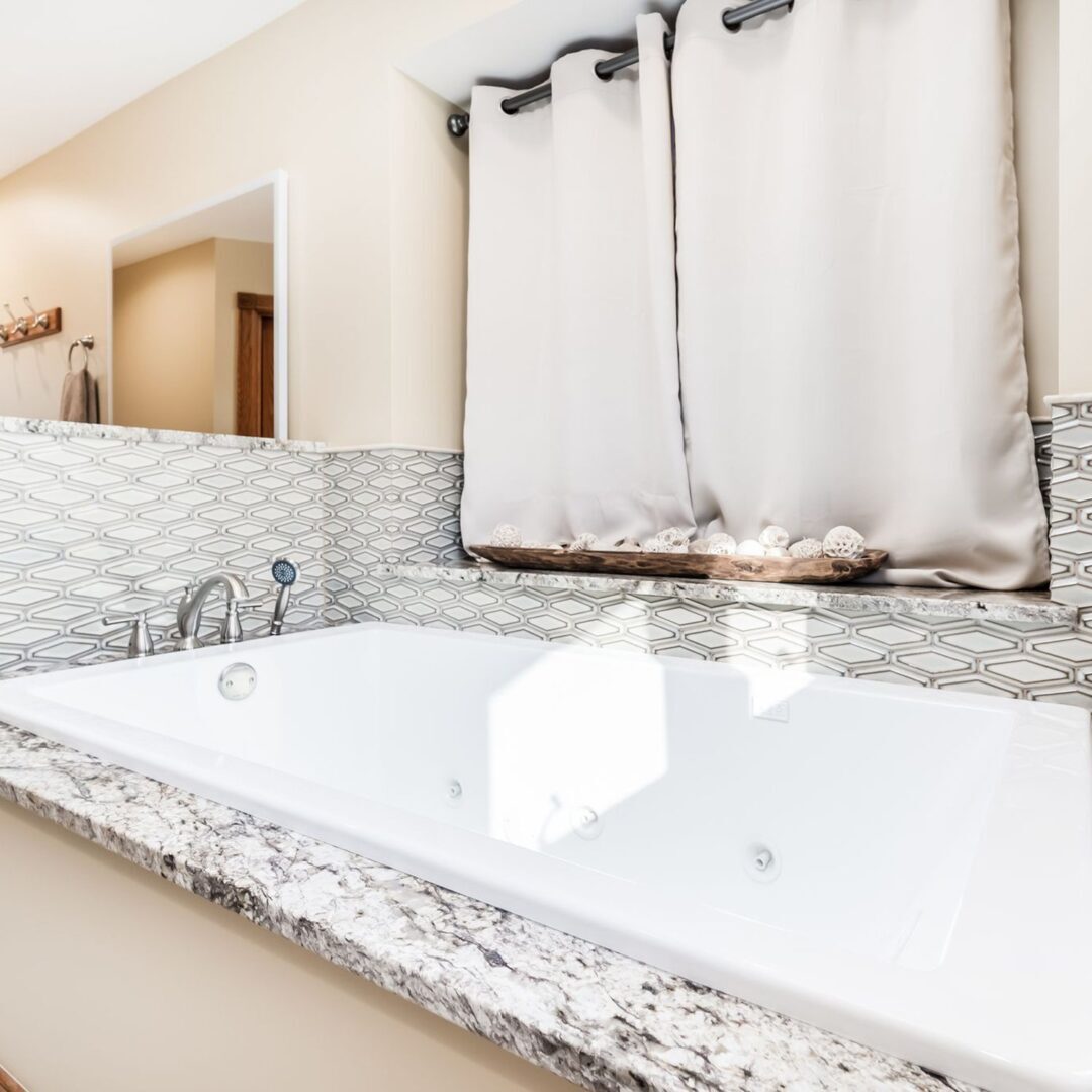 A large white tub sitting next to a sink.