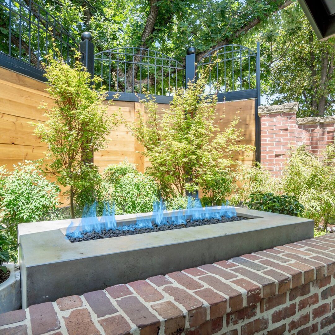 A brick wall with a fire pit in the middle of it